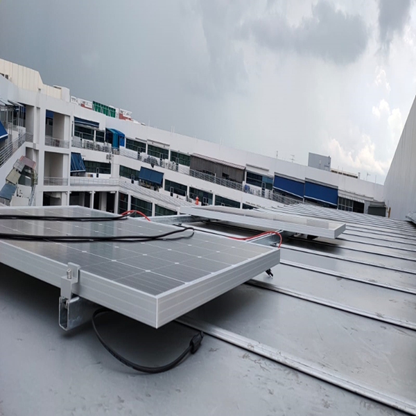 Worker installing solar panels on a roof